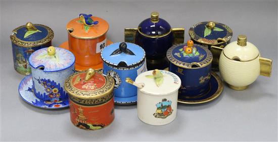 Eight Carlton Ware drum-shaped preserve jars and five stands, various designs and two Art Deco preserve jars